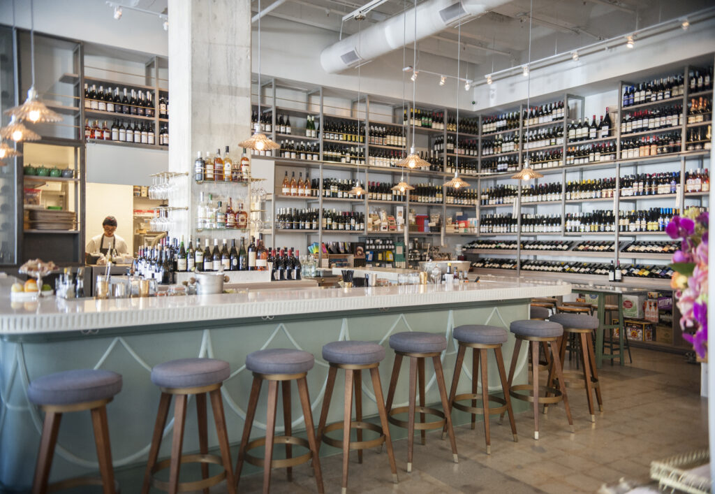 our stunning bar area with stool seating and our collection of wines in the background